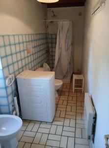 a bathroom with a toilet and a sink at Maison Quercynoise in Corn