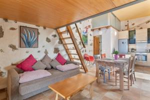a living room with a couch and a table at Finca El Tablero in Tinajo