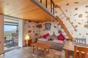 a living room with a couch and a table at Finca El Tablero in Tinajo
