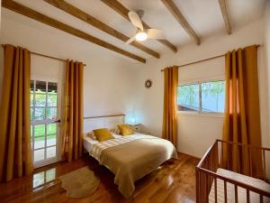 a bedroom with a bed and two windows at Villa Tequila in Adeje +35 photos
