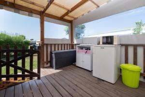 an outdoor patio with a refrigerator and a stove at Mobilhome kervoyal 56 in Damgan