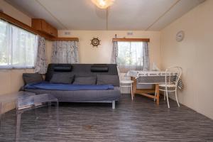 a living room with a couch and a table at Mobilhome kervoyal 56 in Damgan +13 photos