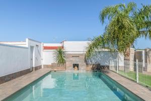 a dog is standing in the water in a swimming pool at Casa Romero in Campano