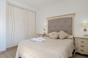 a bedroom with a white bed with towels on it at Casa Romero in Campano +20 photos