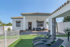 a group of chairs on a lawn in front of a house at Casa Romero in Campano