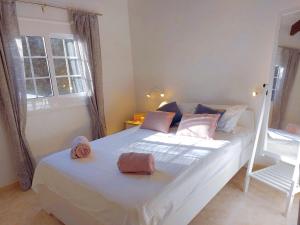 a bedroom with a bed with two towels on it at Casa Dos Mas in Cala en Porter +6 photos