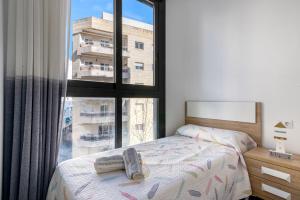 a bedroom with a bed and a large window at Calpe Beach in Calpe +24 photos