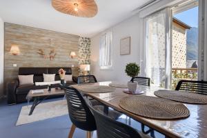 a living room with a table and chairs and a couch at Appartement Bielle 106 in Bielle