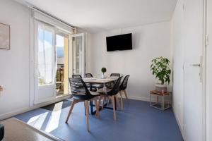 a dining room with a table and chairs and a window at Appartement Bielle 106 in Bielle