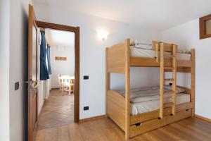 a room with bunk beds and a dining room at Residence Larice Bianco App n5 in Campodolcino