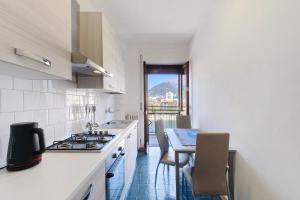 a kitchen with a stove and a table with chairs at La terrazza sull’Adda in Malgrate +11 photos