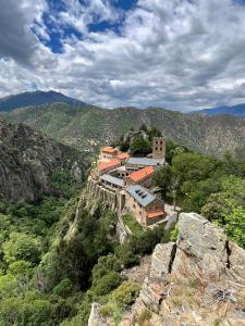 a building on the side of a mountain at Tipi Lodge Glamp Marguerite in Le Boulou