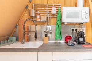 a kitchen counter with a sink and a microwave at Tipi Lodge Glamp Marguerite in Le Boulou +21 photos