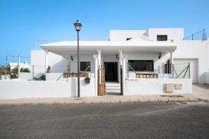 a white building with a street light in front of it at La Ratona in Soo