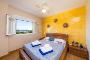 a bedroom with a bed with two blue chairs at Sweet Sea in Port d'Alcudia +22 photos