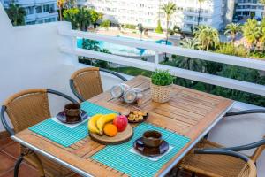 a table with fruit on it on a balcony at Sweet Sea in Port d'Alcudia