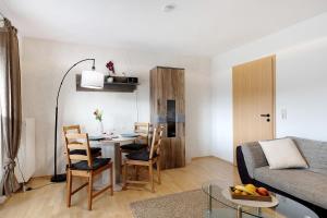 a small living room with a table and a couch at Ferienwohnung Ketterer in Hüfingen
