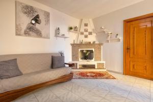 a living room with a couch and a fireplace at La casetta Bianca in Sassari