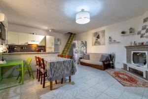 a living room with a table and a couch at La casetta Bianca in Sassari