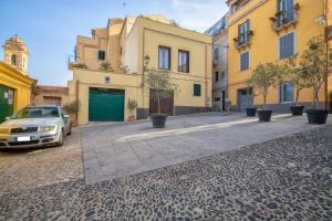 a street with a car parked in front of buildings at La casetta Bianca in Sassari