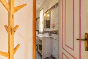 a bathroom with a sink and a mirror at La casetta Bianca in Sassari +11 photos