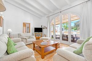a living room with two couches and a coffee table at Finca Son Sanxo in Alaior