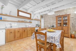 a kitchen with a table and chairs in a room at Finca Son Sanxo in Alaior
