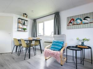 a dining room with a table and chairs at Blauwborst 24-18 in Breukelen +15 photos