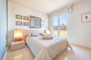 a bedroom with a bed and a large window at Sconto in L'Alfàs del Pi +24 photos