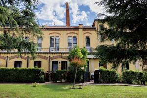 a large yellow building with a chimney on top at Dream Room Apartment in Illasi