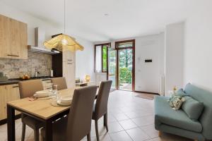 a kitchen and dining room with a table and chairs at Dream Room Apartment in Illasi
