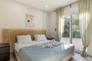 a bedroom with a bed with a towel on it at Euphoria Apartments in Lixouri +45 photos