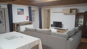 a living room with a couch and a table at Casa do Avô Almeida in Lajes das Flores