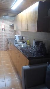 a kitchen with two sinks and a counter top at Casa do Avô Almeida in Lajes das Flores