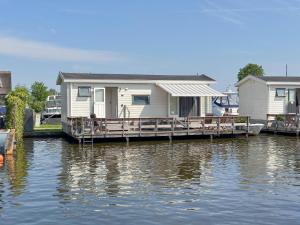 a house on a dock on a body of water at Blauwborst 24-18 in Breukelen