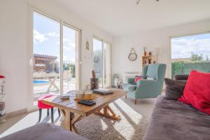 a living room with a couch and a table at Villa M Vallon Pont d'arc in Vallon-Pont-dʼArc