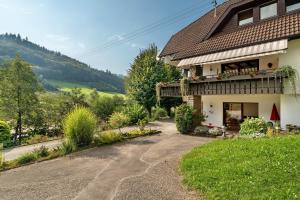 a house with a dirt road in front of it at Haus Schindler in Ottenhöfen