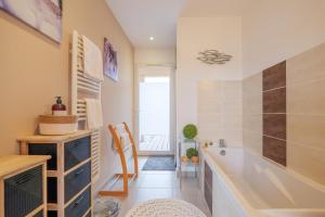 a bathroom with a tub and a sink at Villa M Vallon Pont d'arc in Vallon-Pont-dʼArc +19 photos