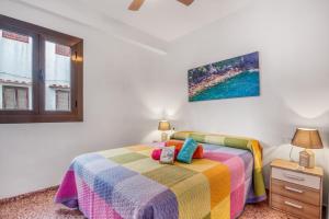 a bedroom with a bed with a colorful blanket at Brooklyn in Oliva