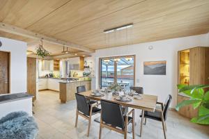 a dining room and kitchen with a table and chairs at Fewo Mit Herz Und Holz Penzing in Penzing