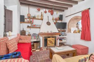 a living room with a red couch and a fireplace at Villa Carlitos in Comares