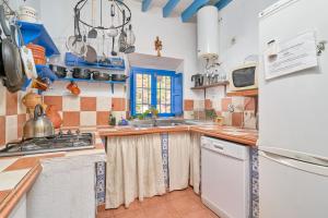 a kitchen with a sink and a refrigerator at Villa Carlitos in Comares