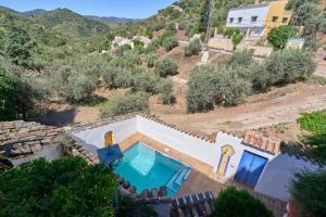 a villa with a swimming pool on a hill at Villa Carlitos in Comares