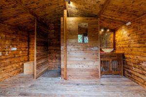 an empty room of a wooden cabin with a window at Tente Glamping Éco-Chic in Auriac-du-Périgord