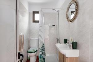 a bathroom with a toilet and a sink and a mirror at La Ratona in Soo +34 photos