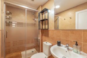 a bathroom with a toilet and a sink and a shower at Vv Caracola in Puerto de Mogán +22 photos