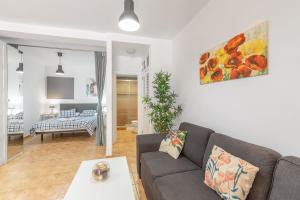 a living room with a couch and a table at Vv Caracola in Puerto de Mogán