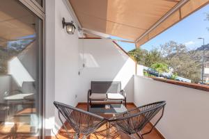 a room with a table and chairs on a balcony at Vv Caracola in Puerto de Mogán