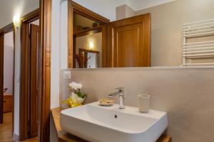 a bathroom with a white sink and a mirror at Podere Sasso 3 in San Gimignano +31 photos