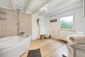 a white bathroom with a tub and a toilet at Grünes Tal - Seenah in Stockach +36 photos